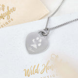 silver tiffany style heart engraved with a dogs pawprint and name